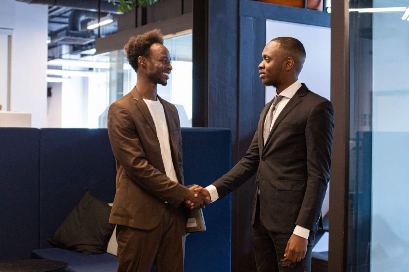 Two people shaking hands after a job placement meeting