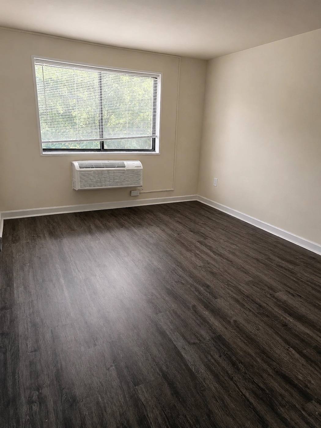 A renovated living space with dark plank flooring