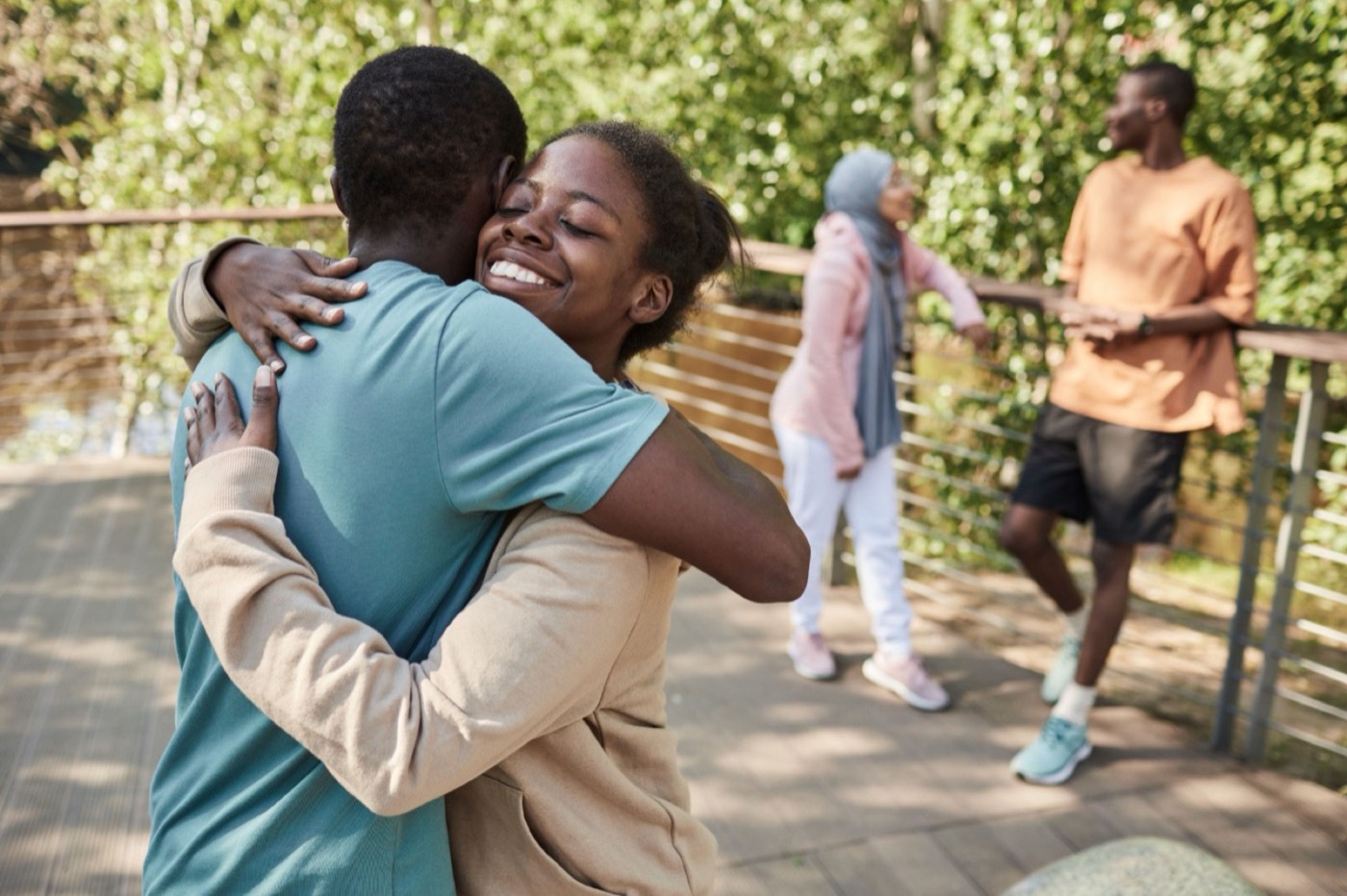 Neighbors greeting each other outdoors on a walking path